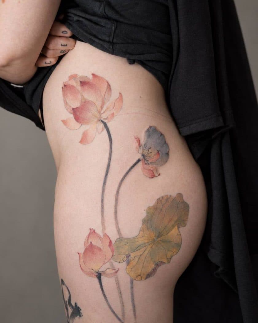 Colour tattoo of lotus flowers and a leaf, on a hip
